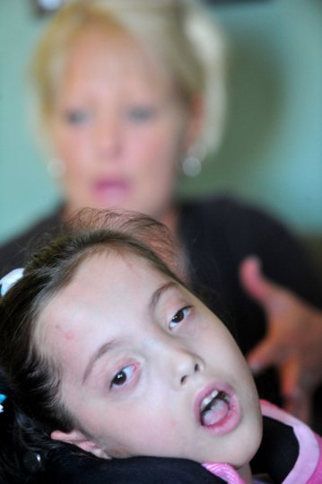 Gracelynn Smith, 5, looks out the window as her mother, Deedee Smith, talks about the difficulties facing Gracelynn during an interview in their home Monday, November 19, 2012 in Athens, Ala. (Eric Schultz / eschultz@al.com)